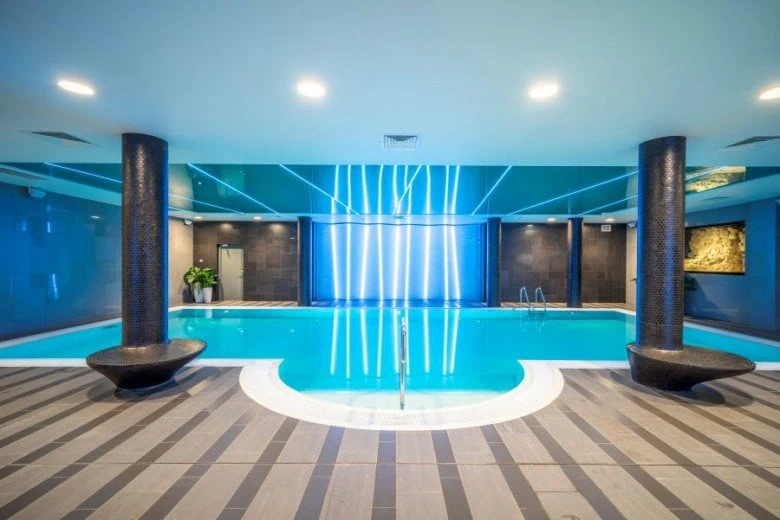 Swimming pool and the interior of Wellton SPA Riverside spa hotel in Riga, Latvia