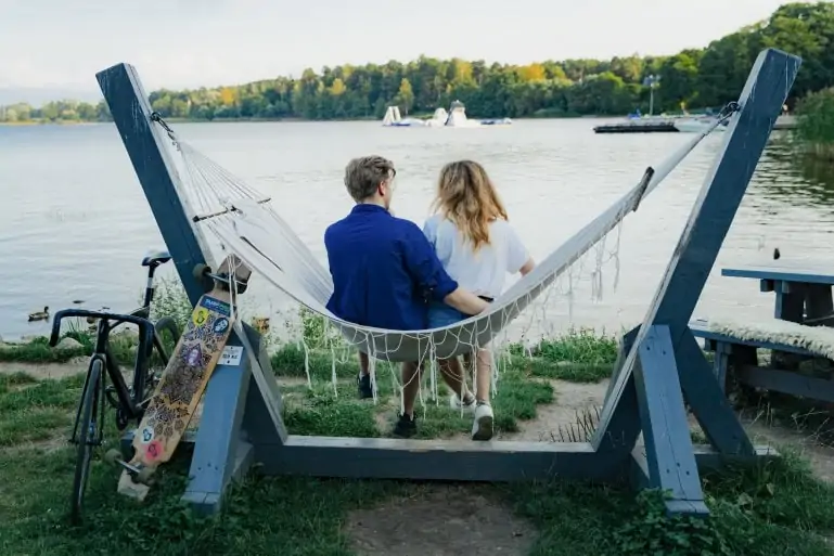 A couple relaxing by a lake and enjoying nature in Riga